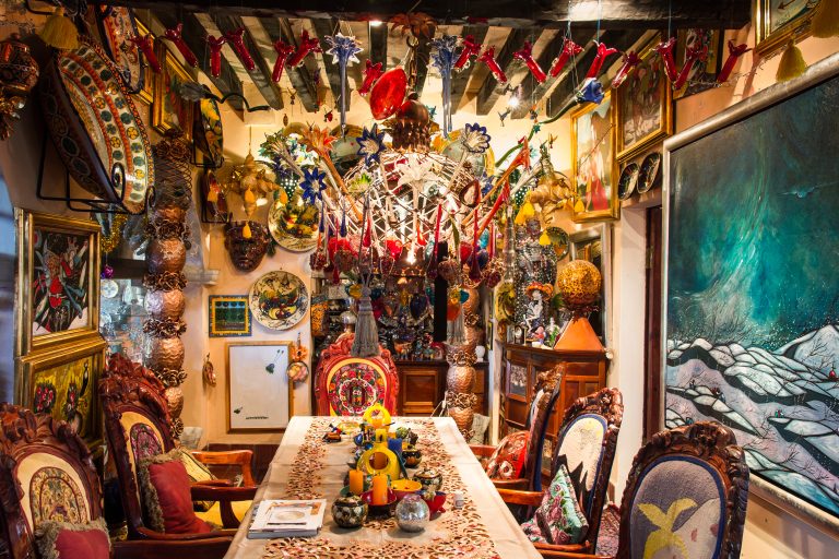 Colorful Mexican art-filled dining room with decorations.